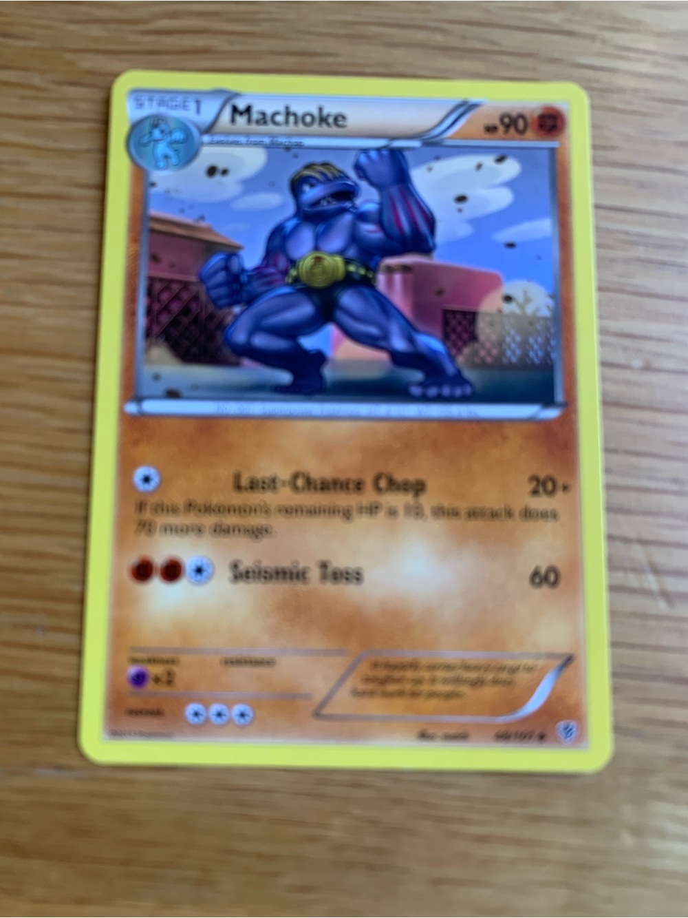 Pokemon Machoke Card with Yellow Border and Orange Playmat Art